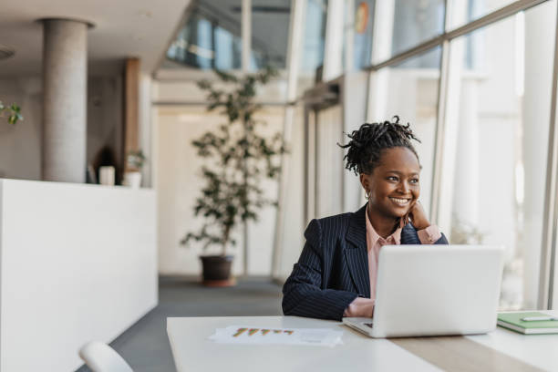 istock Professional Woman Smiling at Her Laptop in Office 2199133090