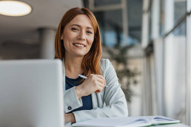 istock Cheerful Businesswoman Smiling at Work 2199133397
