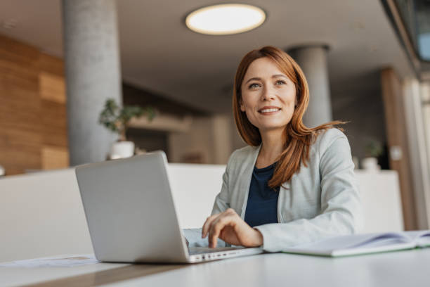 istock Focused Businesswoman in a Bright Office 2199133453