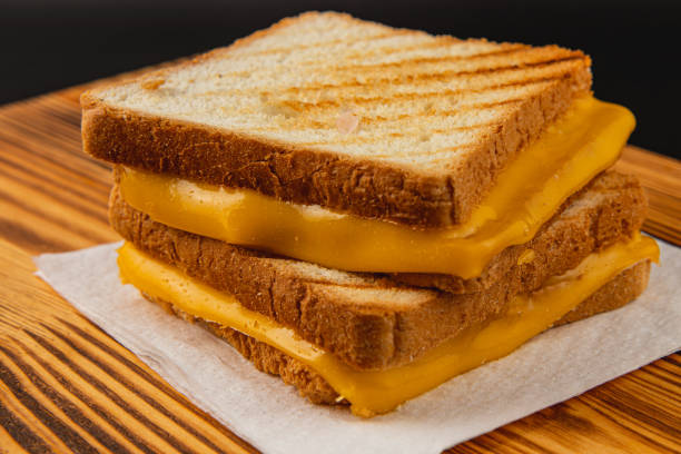 istock Delicious grilled cheese sandwich served on rustic wooden table 2199133523