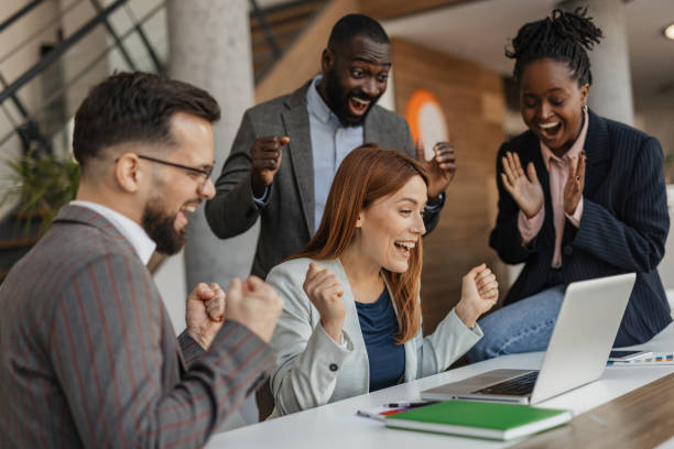 istock Excited Team Celebrating Achievement in the Office 2199133601