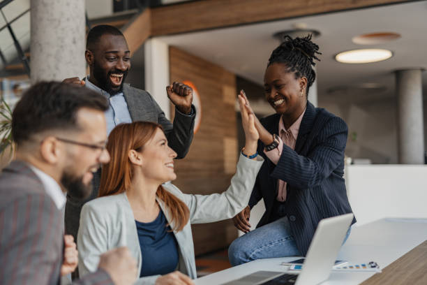 High-Five Celebration of Success Between Team Members
