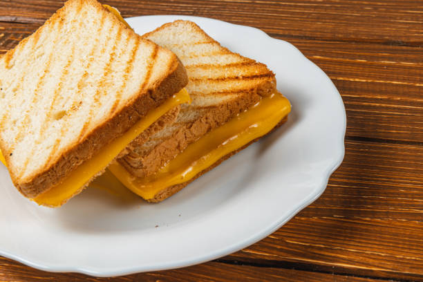 istock Grilled cheese sandwich served on a white plate in a cozy setting 2199135180