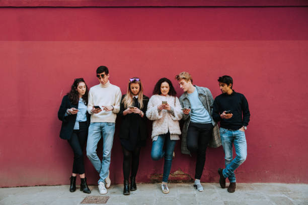 istock Young friends on mobile phone 2199136328