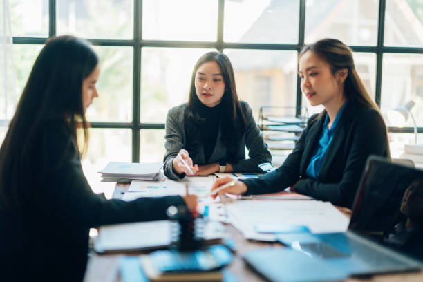 istock Professional businesswomen discussing financial strategy, reviewing charts while working together in contemporary workspace 2199136985