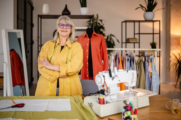 istock Senior woman tailor creating fashionable clothing in her design studio while showcasing her craftsmanship and creativity 2199137125
