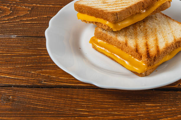 istock Delicious grilled cheese sandwich served on a white plate during breakfast 2199137554