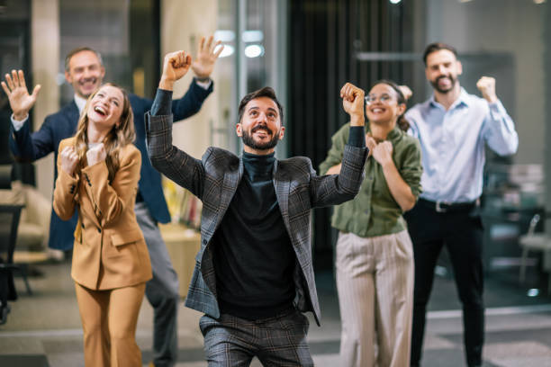 istock Diverse team of professionals posing together in a modern coworking office environment, celebrating their success with cheerful expressions. 2199139014