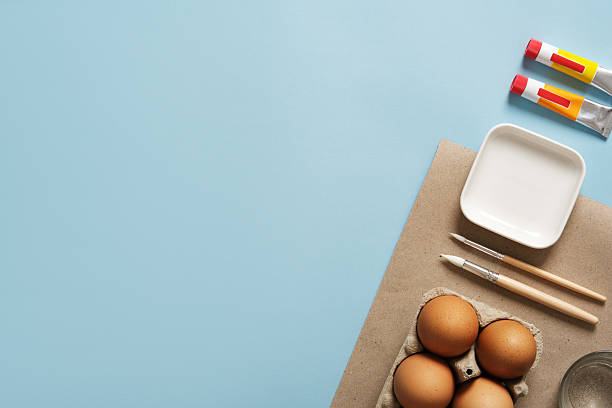 istock Preparation for Easter celebration. Painting Easter eggs with acrylic pigment dyes in tubes. Clean brown eggshells. 2199139255