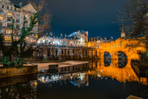 Pulteney bridge reflecting in river avon at night in bath, england