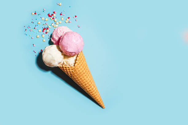 istock Waffle cone with vanilla and strawberry ice cream scoops 2199140625
