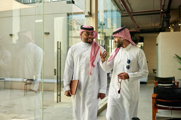 istock Friendly male coworkers walking and talking in modern office 2199141996