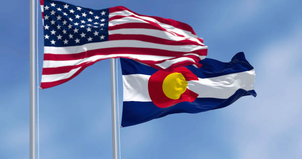 istock Colorado and US flags waving in the wind on a clear day 2199144065