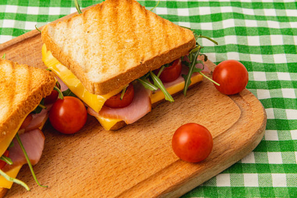 This mouthwatering grilled sandwich features layers of gooey cheese, ham, fresh spinach, and ripe tomatoes. Perfect for a quick lunch or brunch, it offers a delicious homemade touch.