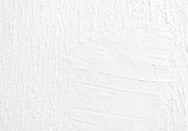 istock Bad stucco repair white paint concrete wall texture background. 2199145123