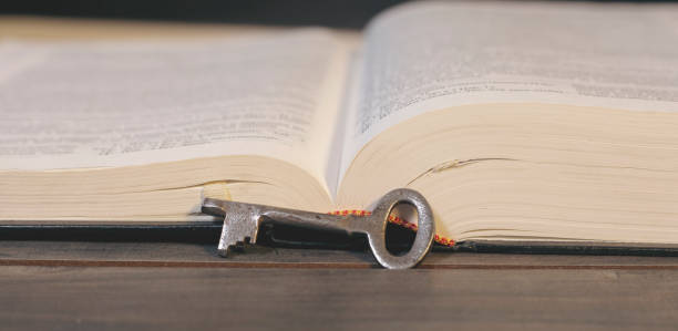 istock Metal key and book on the table 2199146143
