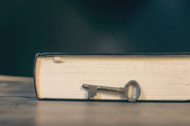 istock Metal key and book on the table 2199146146
