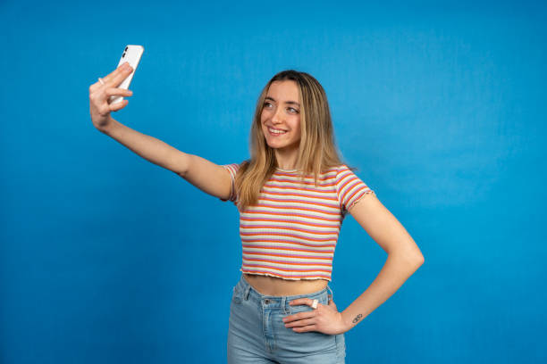 istock Young woman taking a selfie with smartphone 2199147151