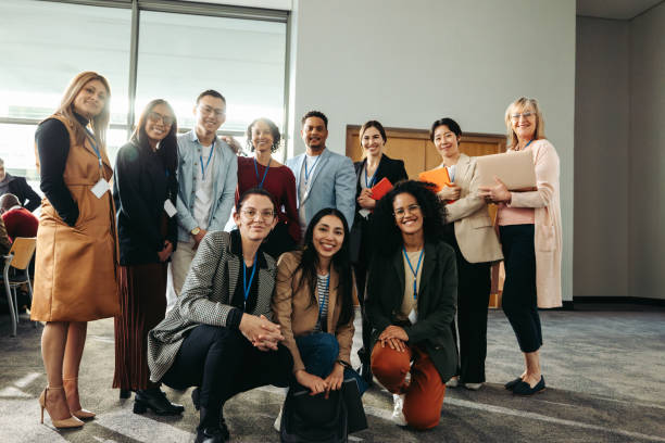 istock Diverse team photo featuring corporate professionals gathered in a modern office environment, highlighting teamwork, collaboration, and diversity in the workplace 2199148331