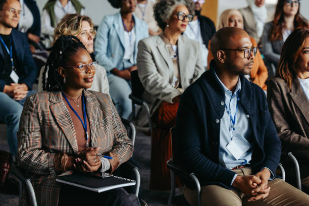 istock Diverse business audience sitting attentively in a workshop or conference setting 2199150990
