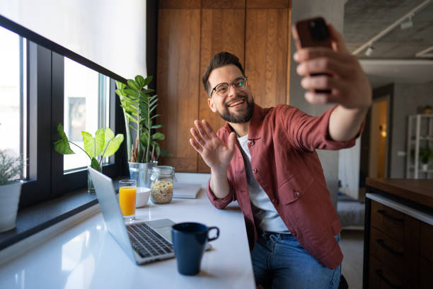 istock Handsome man having a video call at home 2199153031
