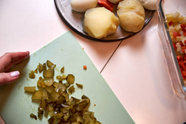 istock a woman cuts up boiled vegetables for an Olivier salad 2199154829