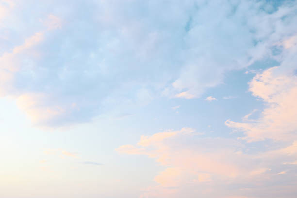 istock Soft pastel clouds stretch across the sky during twilight at a peaceful seaside location 2199155957