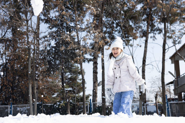Cute girl having fun in the snowy weather