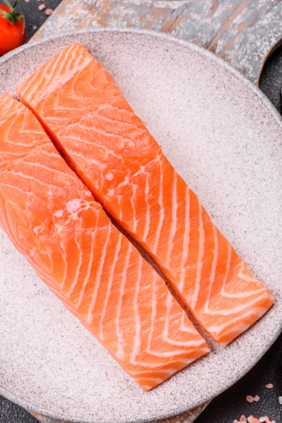 istock Fresh raw salmon steak with spices and herbs 2199157859