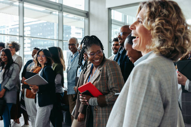 istock Business professionals interacting and laughing during a lively corporate event 2199161394