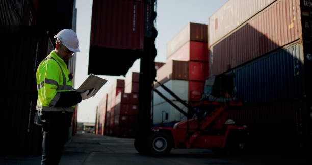 istock A logistic Worker with green safety jacket and PPE work control lifter manage the container at container warehouse shipping yard 2199163833