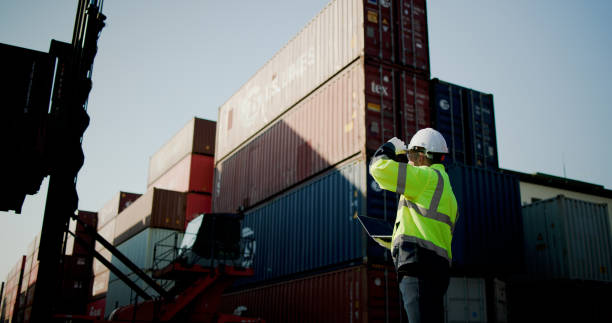istock A logistic Worker with green safety jacket and PPE work control lifter manage the container at container warehouse shipping yard 2199163862