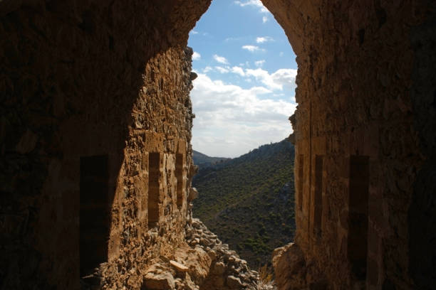 istock View through stone archway of mountainous landscape and sky 2199165095