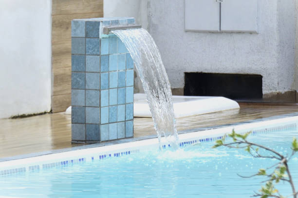 istock In the pool, the water falling gently from the waterfall 2199166649