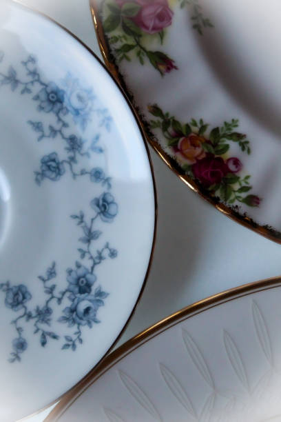mix of porcelain china plates isolated on a table background. different styles of formal dinner dishes. antiques, heirlooms, vintages, estate, organizing flat lay floral backdrop.