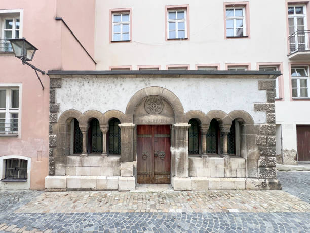 The Crypta S. Hardi in Regensburg, Germany, is a historic underground chamber featuring ancient stone architecture, arched ceilings, and dimly lit passageways. This sacred space, part of St. Emmeram’s Basilica, houses centuries-old tombs and intricate carvings, reflecting the deep religious and cultural heritage of the region. The quiet, atmospheric setting evokes a sense of mystery and reverence, making it a striking representation of Regensburg’s rich history