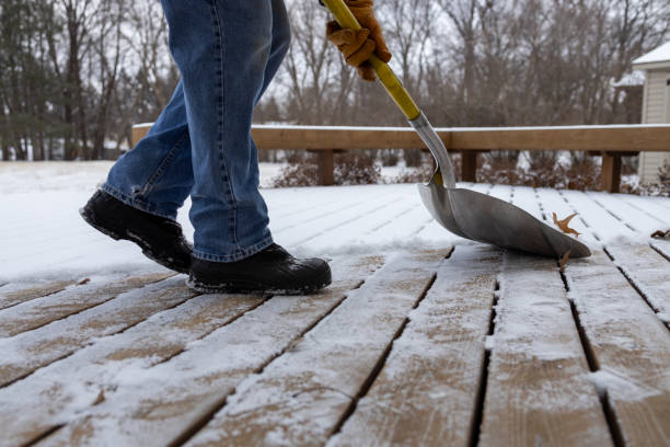 istock Person shoveling snow off a wooden deck 2199175898