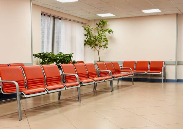 istock A contemporary modern waiting room featuring vibrant orange chairs in a bright, inviting space 2199176036