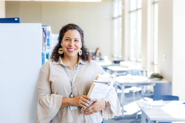 istock Confident Woman Student Holding Books in Library 2199176537