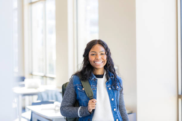 istock Confident African American female student smiling in university hallway 2199176556