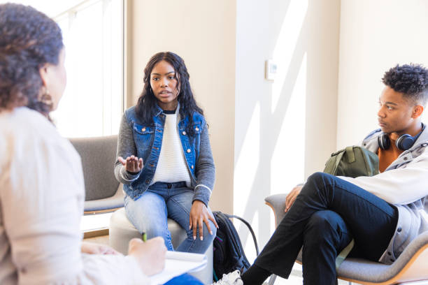 istock Young Woman Leading a Group Therapy Session 2199176557