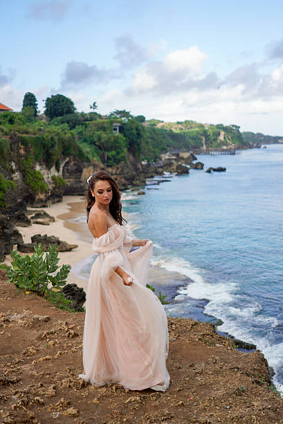 istock A young bride, dressed in pink, stands 2199176649
