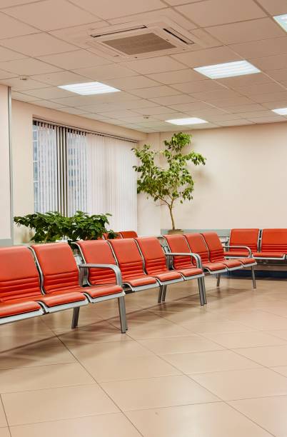 istock A contemporary modern waiting room featuring vibrant orange chairs in a bright, inviting space 2199178140