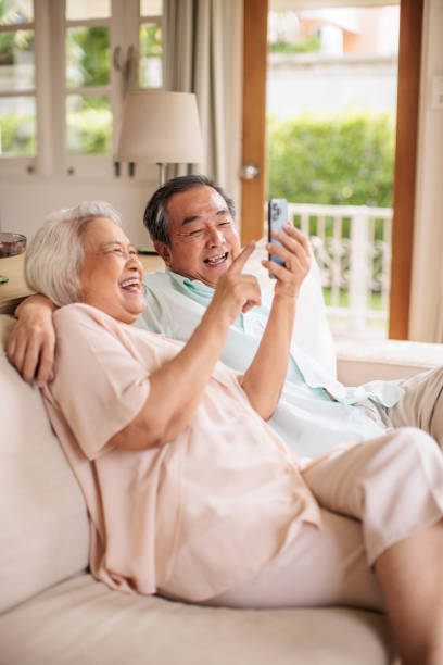 istock Elderly Couple Browsing the Internet on Smart phone Together 2199180950