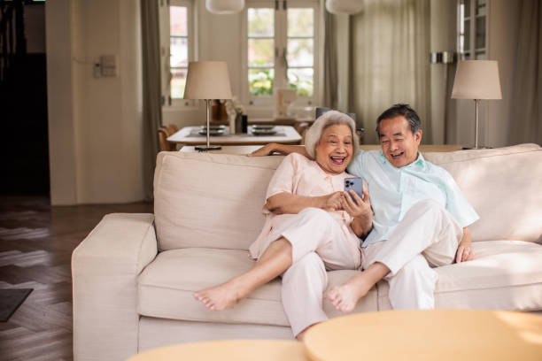 istock Elderly Couple Browsing the Internet on Smart phone Together 2199181021