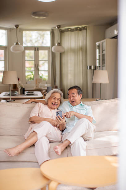 istock Senior Couple Browsing the Internet on Smart phone Together 2199181038