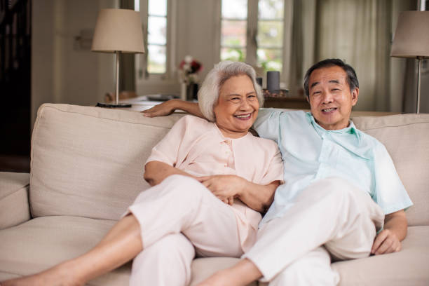 istock Senior Thai Couple Enjoying a Quiet Moment on Sofa 2199181077