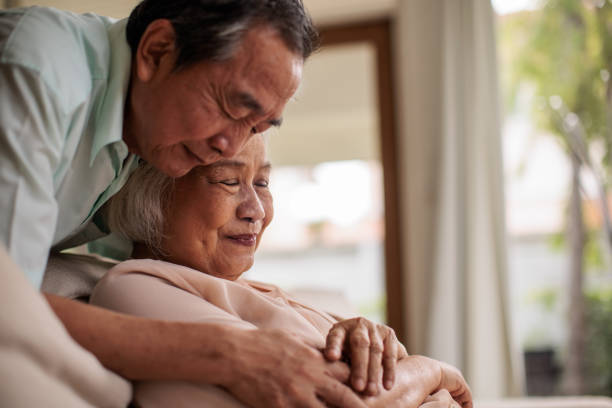 istock Elderly Thai Man Embracing His Wife 2199181308