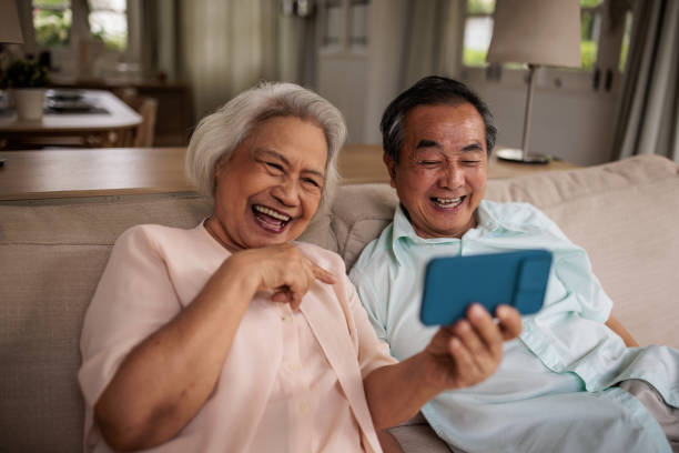 istock Elderly Thai Couple Video Calling Loved Ones Together 2199181463