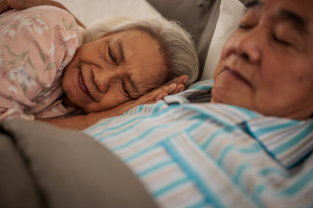 istock Senior Thai Couple Sleeping Peacefully Together 2199181902